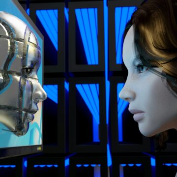 A girl looks at a metal face on a computer